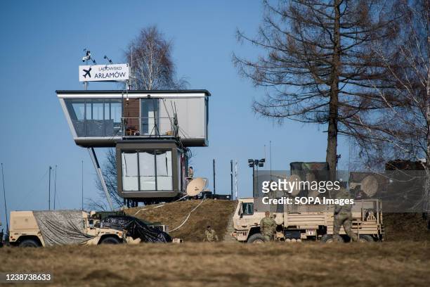 Soldiers and military trucks are seen at the military camp at Arlamow airport. American soldiers arrived in Poland after Pentagon announced...