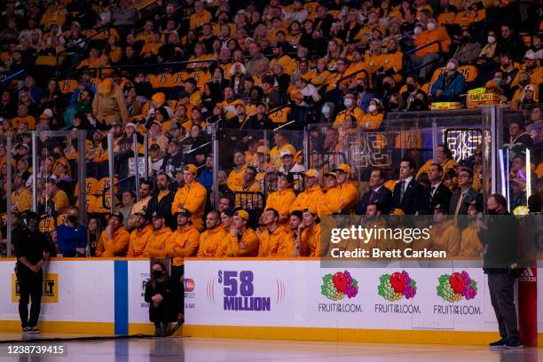 Nashville Predators players watch from the bench during a ceremony to retire the jersey of former goalkeeper Pekka Rinne before the game against the...