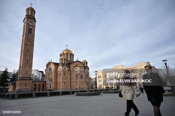 Local residents cross the main square next to the the Orthodox church in Banja Luka, Republika Srpska, on February 17, 2022. - For nearly three...