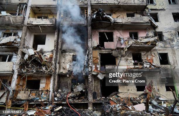 Firemen extinguish a fire inside a residential building that was hit by a missile on February 25, 2022 in Kyiv, Ukraine. Yesterday, Russia began a...