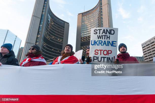 Belarusians with flags in Downtown Nathan Phillips Square during a demonstration against the start of the war of Russian aggressors against Ukraine....