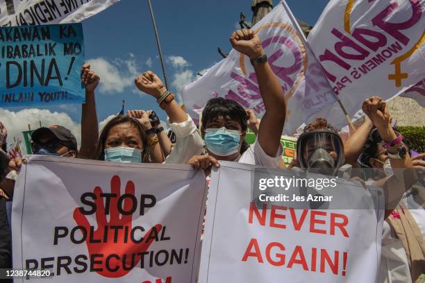 Protesters march to the People Power Monument to commemorate the 36th anniversary of People Power that ousted dictator Ferdinand Marcos, on February...