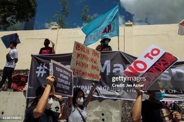 Protesters march to the People Power Monument to commemorate the 36th anniversary of People Power that ousted dictator Ferdinand Marcos, on February...