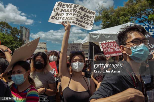 Protesters march to the People Power Monument to commemorate the 36th anniversary of People Power that ousted dictator Ferdinand Marcos, on February...