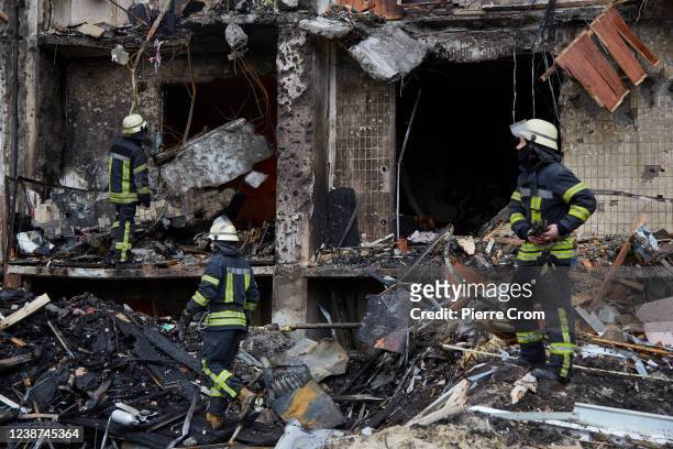 Firemen extinguish a fire inside a residential building damaged by a missile on February 25, 2022 in Kyiv, Ukraine. Yesterday, Russia began a...