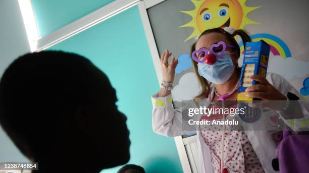 Medical doctors Leslie and Douglas who are in charge of laughter therapy in the general pediatrics section of Valle University Hospital try to bring...