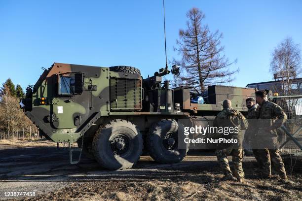 Soldiers of the 82nd Airborne Division and military vehicles are seen at the temporary military base for U.S. Troops established at the Arlamow...