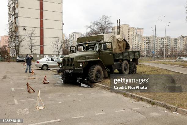 Man takes picture of military vehicle carried russian saboteur group which was eliminated in Kyiv, Ukraine, February 25, 2022.