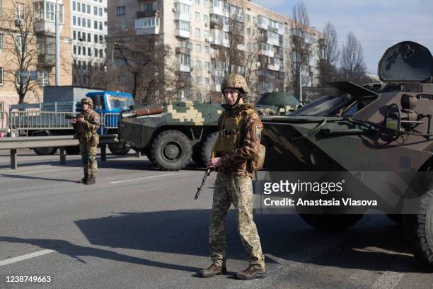 Ukrainian servicemen stand on patrol at a security checkpoint on February 25, 2022 in Kyiv, Ukraine. Yesterday, Russia began a large-scale attack on...