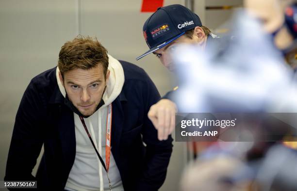 Giedo van der Garde and Max Verstappen of Red Bull Racing in the pit box during the third and final day of testing at Spain's Circuit de...