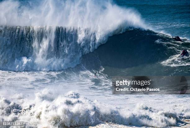 Big wave surfer Antonio Laureano from Portugal rides a wave during a surfing session at Praia do Norte on February 25, 2022 in Nazare, Portugal.