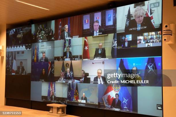 Screen shows world leaders during a video-conference of NATO members at the French Army headquarters in Paris on February 25, 2022. - NATO leaders...