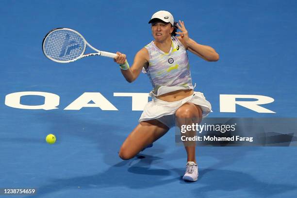 Iga Swiatek of Poland in action against Maria Sakkari of Greece during the Qatar TotalEnergies Open - semi-final at at Khalifa International Tennis...