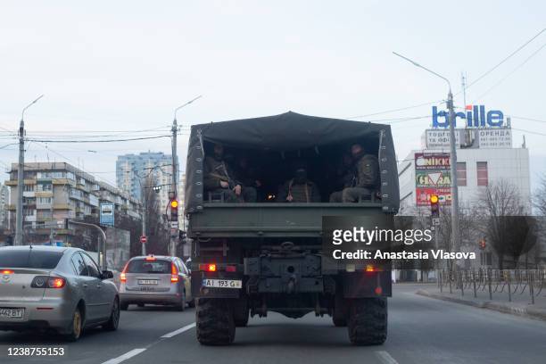 Military vehicle with Ukrainian servicemen drives through the road on February 25, 2022 in Kyiv, Ukraine. Yesterday, Russia began a large-scale...