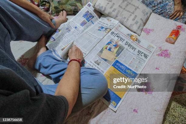 Man reads a Bengali newspaper featuring front page coverage of the Russian invasion of Ukraine at a household in Kolkata , India , on 25 February...