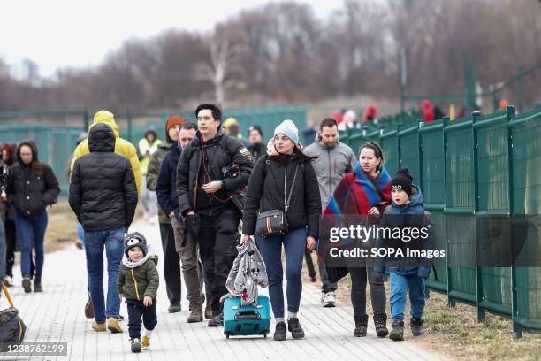 Kids and Ukrainian families seen walking through the border crossing passage as Russia takes more Ukrainian territory. As the Russian Federation army...