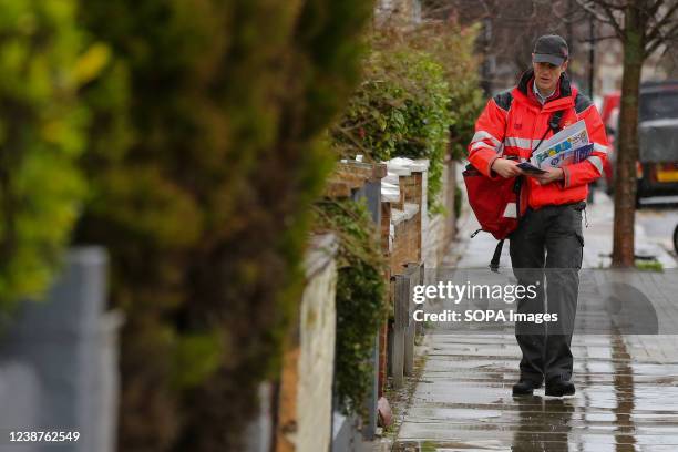 Postman is seen delivering the letters in a residential area.