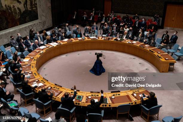 Members of the United Nations Security Council cast their votes during a meeting at United Nations headquarters on February 25, 2022 in New York...