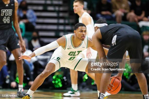 Clyde Trapp of the Charlotte 49ers defends Eric Lovett of the Florida International Golden Panthers as he brings the ball down the court to start a...
