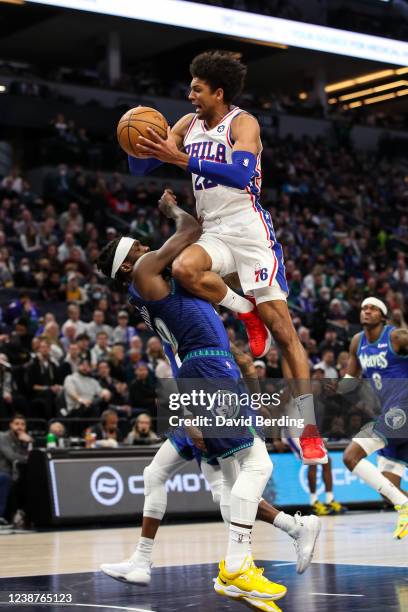 Matisse Thybulle of the Philadelphia 76ers draws a foul against Patrick Beverley of the Minnesota Timberwolves in the second quarter of the game at...