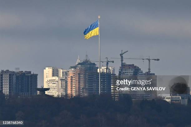 Ukraine's biggest national flag flies in Kyiv on February 26, 2022. - After Ukrainian forces said they had repulsed a Russian attack on their capital...