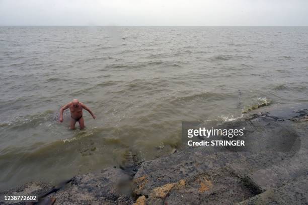Man takes a swim in the Sea of Azov in the southwestern Russian port city of Taganrog, 50 km from the Ukrainian border and the self-proclaimed...