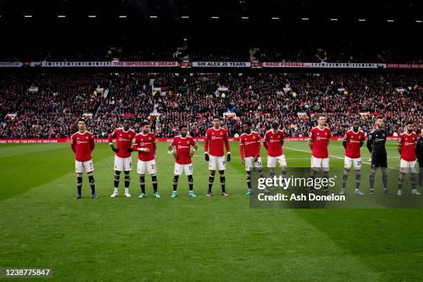 The Manchester United players line up prior to the Premier League match between Manchester United and Watford at Old Trafford on February 26, 2022 in...