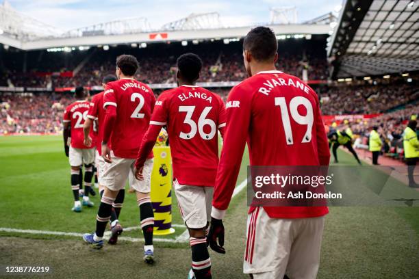 Raphael Varane of Manchester United walks out to the pitch with his team-mates prior to the Premier League match between Manchester United and...