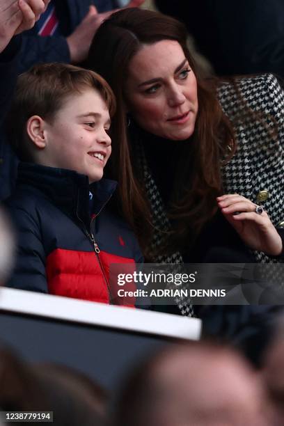 Britain's Prince George of Cambridge talks to his mother Britain's Catherine, Duchess of Cambridge as they attend the Six Nations international rugby...