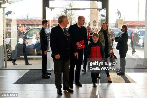 Britain's Prince William, Duke of Cambridge, Catherine, Duchess of Cambridge and their son Prince George of Cambridge arrive to watch the Guinness...