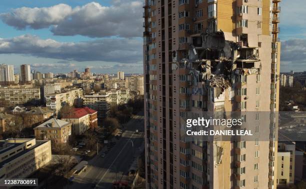 This general view shows damage to the upper floors of a building in Kyiv on February 26 after it was reportedly struck by a Russian rocket. - Russia...