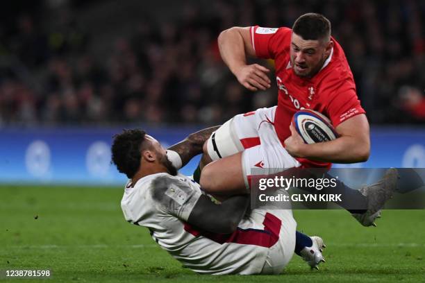 Wales' prop Gareth Thomas is tackled by England's flanker Courtney Lawes during the Six Nations international rugby union match between England and...