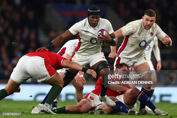England's lock Maro Itoje is tackled during the Six Nations international rugby union match between England and Wales at Twickenham Stadium, west...