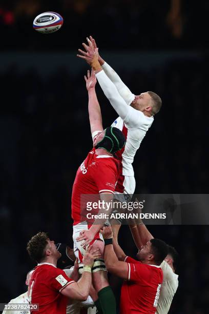 England's Nick Isiekwe and Wales' lock Adam Beard compete for line-out ball during the Six Nations international rugby union match between England...