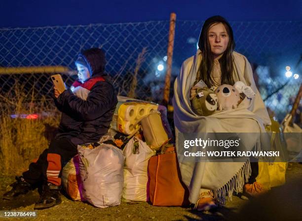 Helena and her brother Bodia from Lviv are seen at the Medyka pedestrian border crossing, in eastern Poland on February 26 following the Russian...