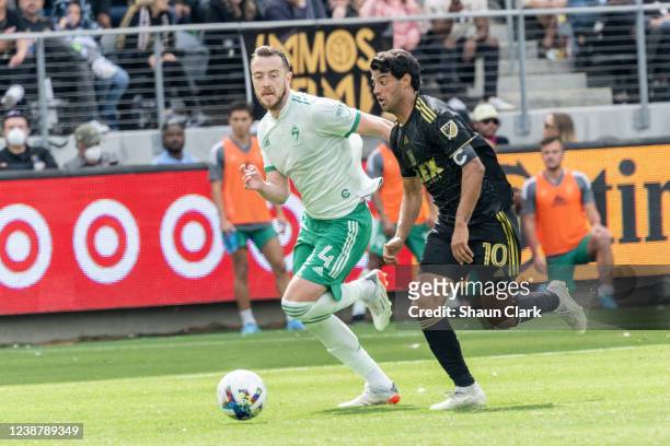 Carlos Vela of Los Angeles FC battles Danny Wilson of Colorado Rapids during the match at Banc of California Stadium in Los Angeles, California on...