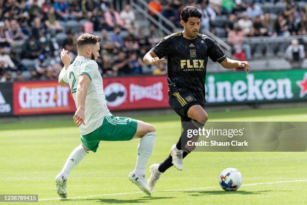 Carlos Vela of Los Angeles FC battles Keegan Rosenberry of Colorado Rapids during the match at Banc of California Stadium in Los Angeles, California...