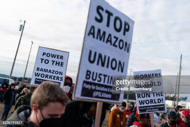 Demonstrators hold signs at a rally in support of a union for Amazon workers in Bessemer, Alabama, U.S., on Saturday, Feb. 26, 2022. The Retail,...