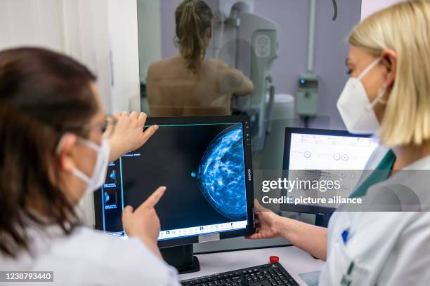 February 2022, Berlin: Medical personnel use a mammogram to examine a woman's breast for breast cancer. Breast cancer patients are unsettled: The...