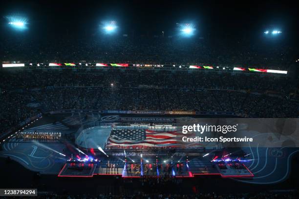 An American flag is unveiled on the ice during the National Anthem prior to the Navy Federal Credit Union Stadium Series game between the Nashville...