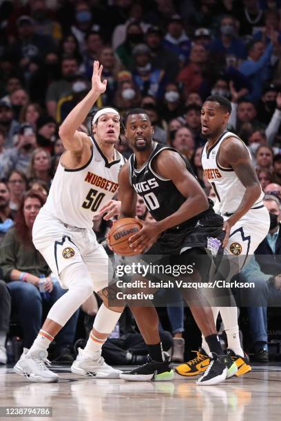 Harrison Barnes of the Sacramento Kings looks for a teammate against Aaron Gordon of the Denver Nuggets and Michael Porter Jr. #1 of the Denver...