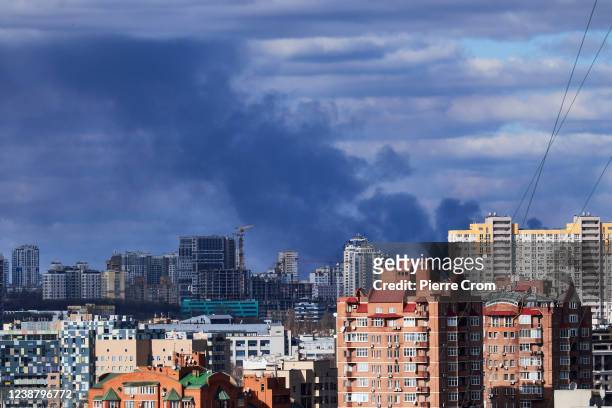 Smoke is seen rising from behind buildings following bombings on February 27, 2022 in Kyiv, Ukraine. Explosions and gunfire were reported around Kyiv...