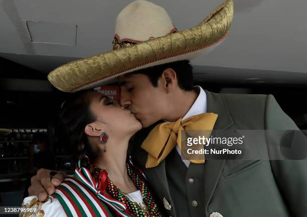 Charro and a skirmish kiss in the bar area at the Hipódromo de Las Américas located in Mexico City, where some exhibitions were held, such as floreo...