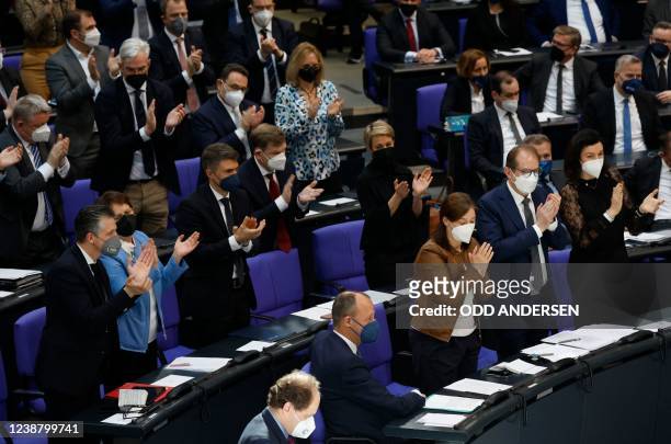 Leader of Germany's Christian Democratic Union Friedrich Merz is applauded after his speech during an extraordinary session of the Bundestag on...
