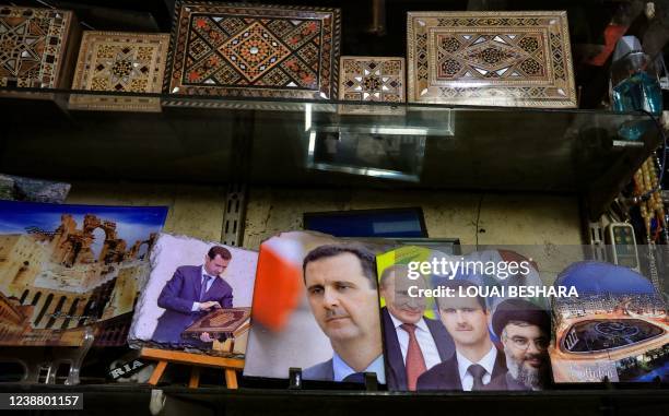 Objects with images of Syrian President Bashar al-Assad, Russian President Vladimir Putin and head of the Lebanese Shiite movement Hezbollah Hassan...