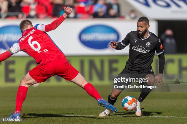 Patrick Mainka of 1.FC Heidenheim 1846 and Cebio Soukou of SV Sandhausen 1916 battle for the ball during the Second Bundesliga match between 1. FC...