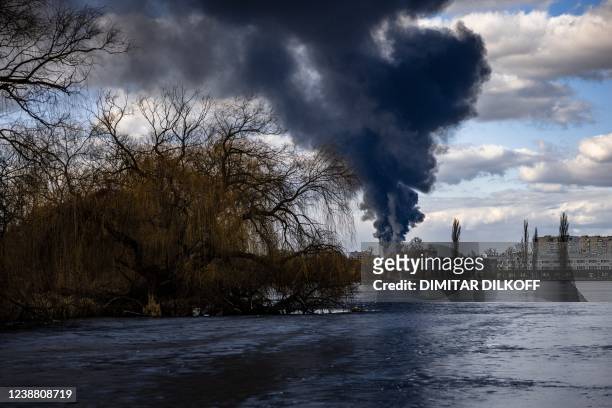 Smoke billows over the town of Vasylkiv just outside Kyiv on February 27 after overnight Russian strikes hit an oil depot. - Ukraine's foreign...