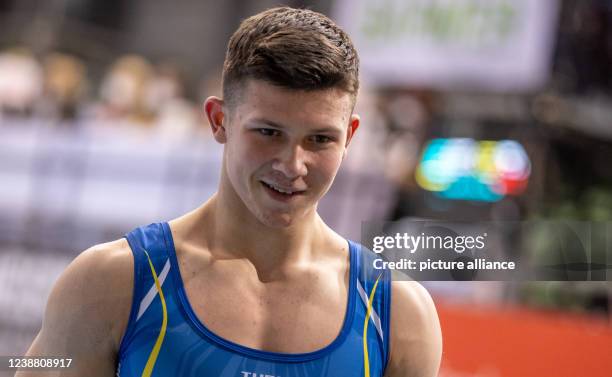 February 2022, Brandenburg, Cottbus: Gymnastics: World Cup, men: parallel bars, decision in the Lausitz Arena. Illia Kovtun from Ukraine smiles. He...