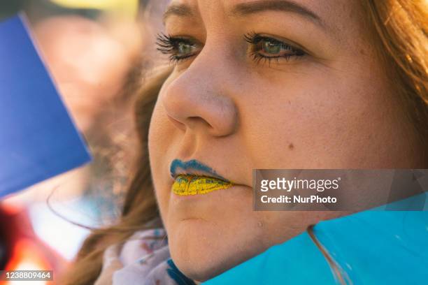 A protester with Ukraine patriotic lipstick is seen in front of the Dom Cathedral in Cologne, Germany on February 27, 2022 during the biggest anti...