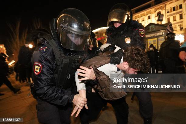Police officers detain a demonstrator during a protest against Russia's invasion of Ukraine in central Saint Petersburg on February 27, 2022.